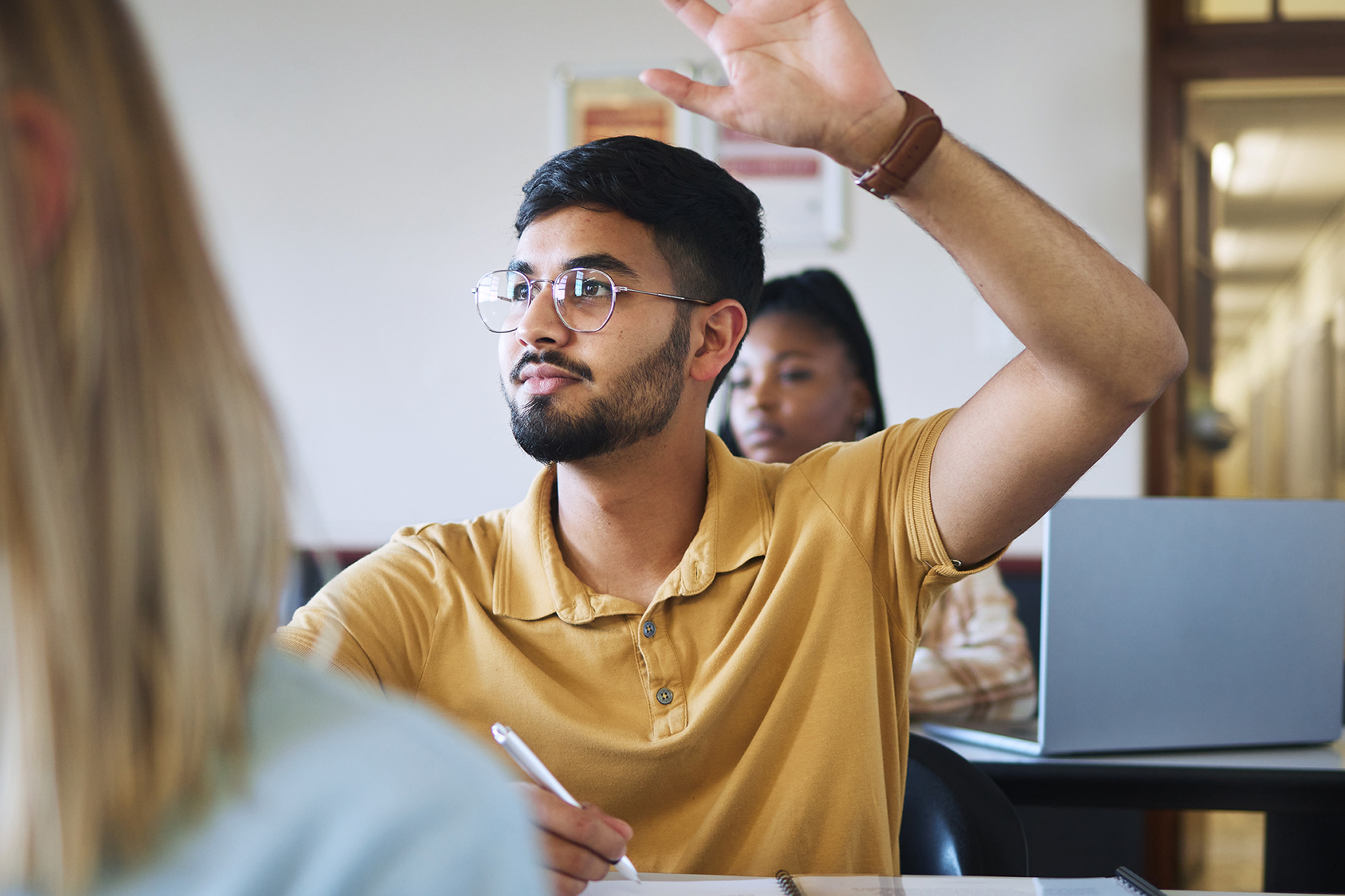 student raising hand at orientation